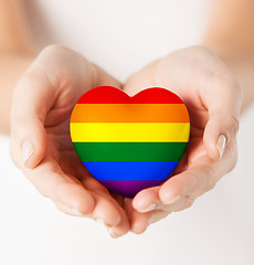 Image showing female hands with small rainbow heart
