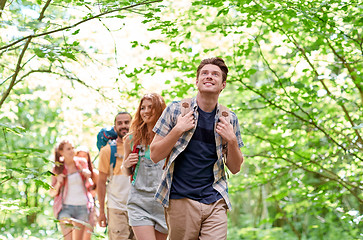 Image showing group of smiling friends with backpacks hiking