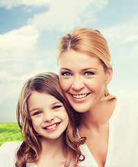 Image showing smiling mother and little girl