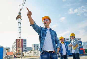 Image showing builders pointing finger aside on construction