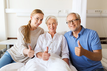 Image showing happy family visiting senior woman at hospital