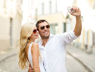 Image showing travelling couple taking photo picture with camera