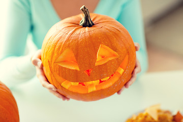 Image showing close up of woman with pumpkins at home