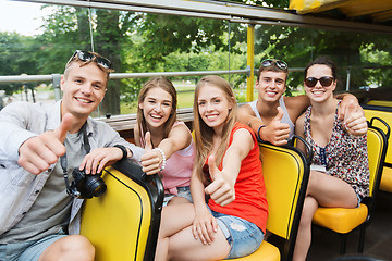 Image showing friends traveling by tour bus showing thumbs up