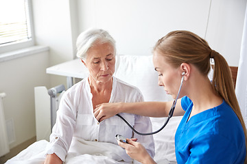 Image showing nurse with stethoscope and senior woman at clinic