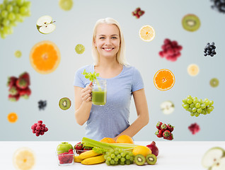 Image showing smiling woman drinking juice or shake at home