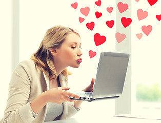Image showing woman sending kisses with laptop computer