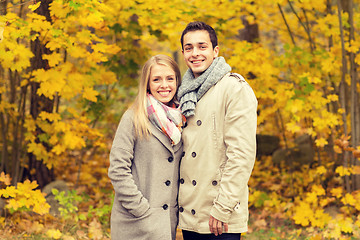 Image showing smiling couple hugging in autumn park