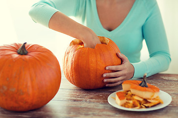 Image showing close up of woman with pumpkins at home