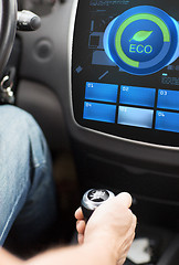 Image showing hand with gearshift and car eco mode on screen