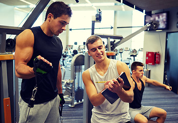 Image showing men exercising on gym machine