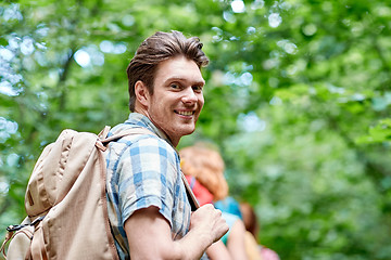 Image showing group of smiling friends with backpacks hiking