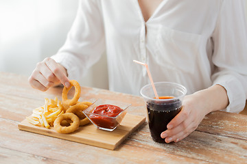 Image showing close up of woman with snacks and cocacola