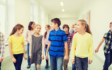 Image showing group of smiling school kids walking in corridor