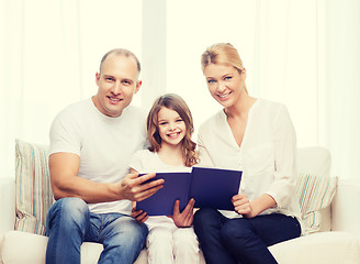 Image showing smiling parents and little girl with at home