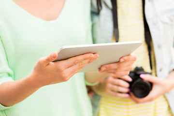 Image showing close up of women with tablet pc and camera