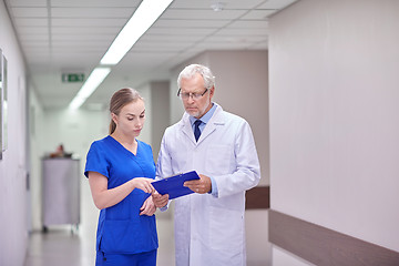 Image showing senior doctor and nurse with tablet pc at hospital