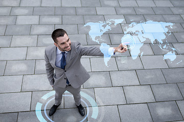 Image showing smiling businessman with world map projection