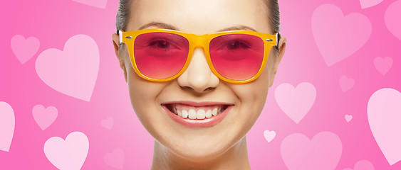 Image showing smiling teenage girl in pink sunglasses