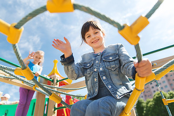 Image showing happy little girl climbing on children playground