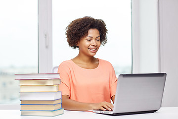 Image showing happy african american woman with laptop at home