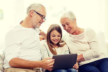 Image showing smiling family with tablet pc at home