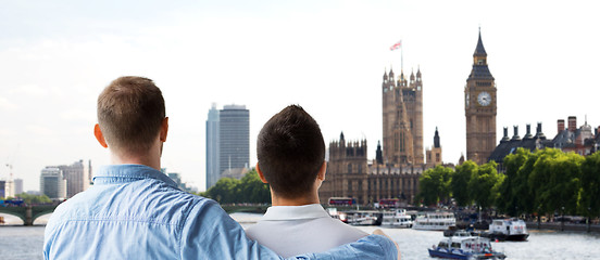 Image showing close up of male gay couple hugging over big ben