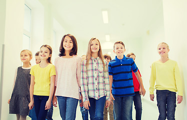 Image showing group of smiling school kids walking in corridor