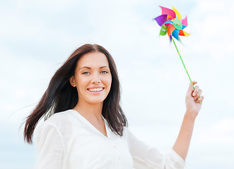 Image showing girl with windmill toy on the beach