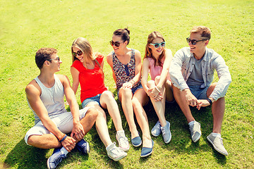 Image showing group of smiling friends outdoors sitting in park