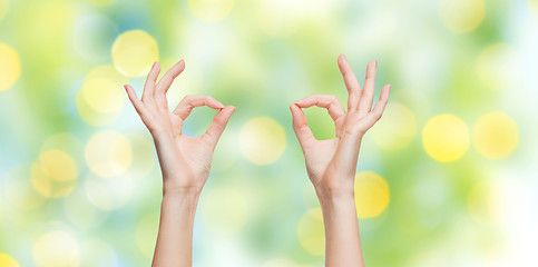 Image showing woman hands showing ok sign over blue sky