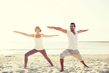 Image showing couple making yoga exercises outdoors