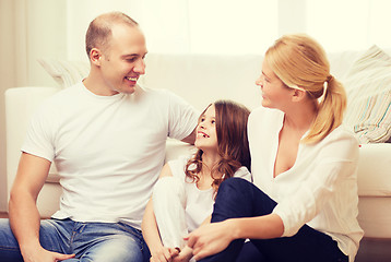 Image showing parents and little girl sitting on floor at home