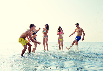 Image showing happy friends having fun on summer beach