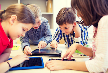 Image showing group of school kids with tablet pc in classroom