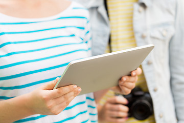 Image showing close up of women with tablet pc and camera