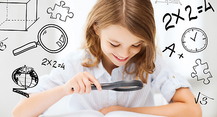 Image showing girl reading book with magnifier at school