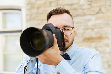 Image showing young hipster man with digital camera in city