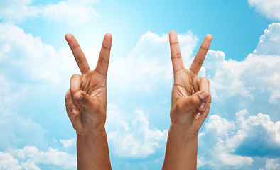 Image showing two african hands showing victory or peace sign