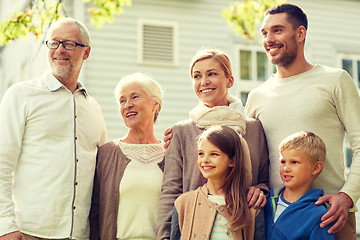 Image showing happy family in front of house outdoors