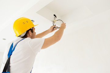 Image showing close up of builder or electrician running wires