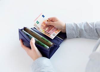 Image showing close up of woman hands with wallet and euro money