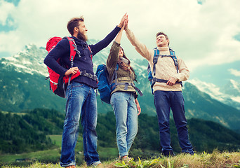 Image showing group of smiling friends with backpacks hiking