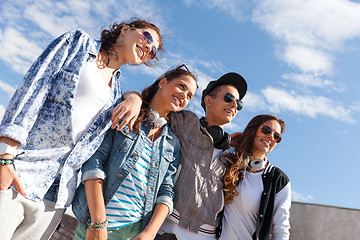 Image showing smiling teenagers in sunglasses hanging outside