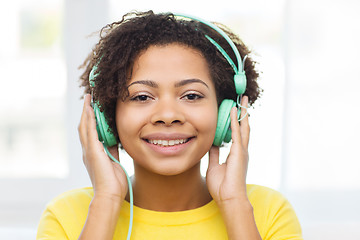 Image showing happy woman with headphones listening to music