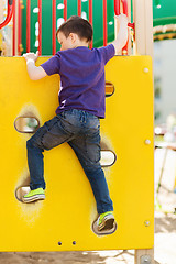 Image showing happy little boy climbing on children playground