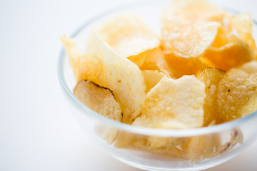 Image showing close up of crunchy potato crisps in glass bowl