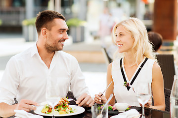 Image showing happy couple eating dinner at restaurant terrace