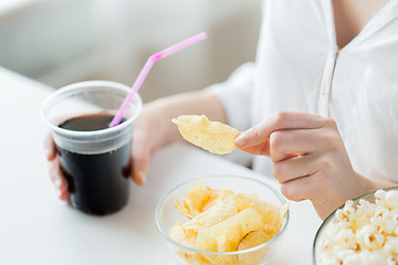 Image showing close up of woman with junk food and coca cola cup