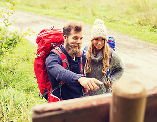 Image showing smiling couple with backpacks hiking